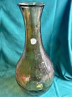 Front view of the amber Vidrios San Miguel vase showing the bulbous ribbed lower body and smooth neck with a clear lip.