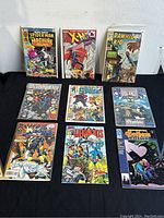 Image of nine vintage Marvel comic books laid out in two rows showing different titles and cover art.