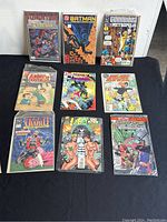 Photo showing 9 vintage comic books arranged on a flat surface, titles visible include Daredevil, Batman, Guardians of Metropolis, Abbott & Costello, Deathmask and Mystic, Blue Devil, Diablo, Lobo, and Star Trek.