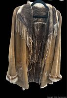 Front view of suede and fur jacket showing fringe details on collar and pockets