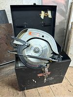 Craftsman Sears circular saw inside metal carrying case showing the saw and some accessories.