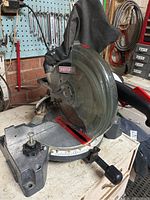 Detailed frontal view of mitre saw showing angle scale and blade guard with Craftsman branding.