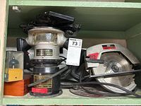 Craftsman circular saw and router with router bits stored in a green wooden box