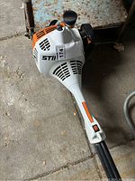 Close-up of engine housing showing Stihl logo and model label.