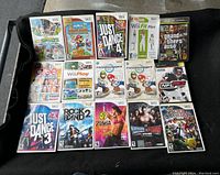 Photo of 13 Wii games and 1 Xbox 360 game including titles like Mario Party 9, Just Dance 4, Wii Fit Plus, and Grand Theft Auto IV