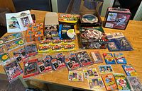Full view of baseball cards, packs, lunchbox, puzzles, and various memorabilia on table