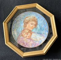 Front view of the framed Edna Hibel Mother's Day plate featuring mother and child illustration