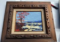 Full view of framed Morris Katz oil painting showing ocean scene with tree and waves, wood carved frame and linen mat around painting.