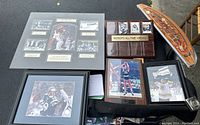 Overall view of all New England sports memorabilia items displayed on a black surface.