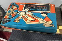 Photo of the vintage Remco Giant Wheel Thrills 'n' Spills Horse Race Game box showing colorful 1950s style artwork depicting children playing the game with horses and the giant wheel.