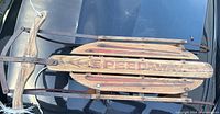 Photo of the vintage Speedway sled showing the top wooden slats with 'SPEEDWAY' painted in red with weathering and wear consistent with age.