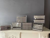 6 different clear acrylic jewellery organizer modules stacked, showing drawer fronts with clear acrylic knobs and flocked brown lining inside.