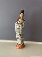 Full view of the standing porcelain Guan Yin figurine with detailed robe and base.