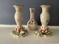 Front view showing pair of Lenox Floral Frog candlesticks with lotus leaf base and Irish bud vase with multicolor floral design