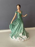 Front view of Royal Doulton Andrea figurine in green dress showing elegant pose and fine details.