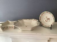 Three Spode Christmas Jubilee pieces shown together including large bowl, medium bowl, and candy dish on white mantel against grey background