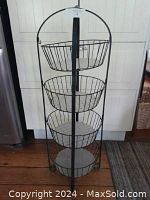 Full vegetable basket stand with four baskets shown upright.
