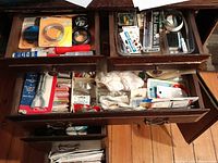 Top drawer with smaller sewing items such as needles, zippers, elastic, bias tape, and various packaged notions.