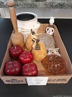 Box with various decor items including 4 red wood apples, 2 fabric pears, 1 wooden mallet, electric candle warmer, mini oil lamp, and multiple flower frogs.