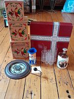 Full lot showing Holmar canisters, Dansk platter box, metal wall hook, acrylic organizer, vase, and ceramic jug.