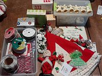 Overview of Christmas decorations and crafting items including felt tree skirt, candle holder, ribbon spools, dolls and beads bin