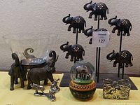 Image of all the listed elephant-themed items grouped together showing the variety in size, material, and function.