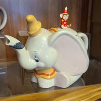 Side view of Dumbo ceramic teapot with Timothy Q. Mouse figure on lid showing full design and color.