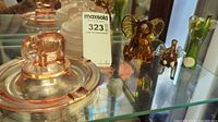 Photo showing pink depression glass covered dish with elephant handle on lid and small pink ashtray. Also amber blown glass elephant figurines.