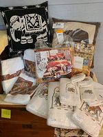 Overview of lot with elephant themed decorative pillows, towels, washcloths, bedding and more, all new or new in packaging.