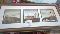 Framed lighthouse triptych showing three coastal lighthouse scenes in wood frame with white matting.