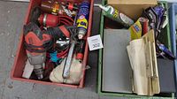 Photo of two totes containing various hand tools, spray cans, cables, and other garage items.