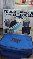 Front box showing trunk organizer with integrated insulated cooler and an additional P&G softside cooler in front.