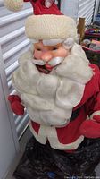 Close-up of vintage Coca Cola Santa's face showing molded plastic features and plush white beard