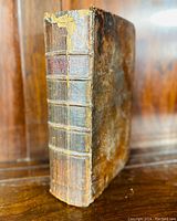 Angled view of spine and front cover showing raised bands and overall binding condition