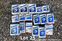 17 oil filter boxes from Defense and Protech brands arranged on a gravel surface.