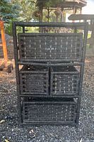 Wicker drawer set with three drawers in a dark woven wicker material for lightweight storage, shown outdoors.