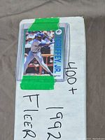 Box of baseball cards labeled 400+ 1992 Fleer Baseball with taped Ken Griffey Jr. card on top