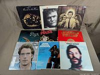 Front view of the 9 vinyl record albums arranged in a 3x3 grid, displaying cover art and artist names including Band on the Run, Gordon Lightfoot, Pete Townshend, Styx, The Police, Jefferson Starship, Huey Lewis and the News, Born Losers, and Ringo Starr.
