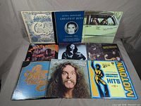 Nine vinyl records with front cover artwork visible including Chicago Transit Authority, Linda Ronstadt Greatest Hits, Cheech & Chong, Yorkville Revolution, Rachel Sweet, George Thorogood, Ted Nugent Cat Scratch Fever and Motown Hits compilation.