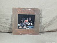 Rear side of the album cover showing a band photograph of Aerosmith and some background text.