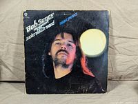 Front cover of Bob Seger and The Silver Bullet Band 'Night Moves' album showing close-up portrait of Bob Seger with light orb on dark background.