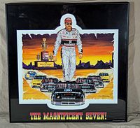 Full view of the framed print showing the artwork with Dale Earnhardt and cars against a sunset background, black frame