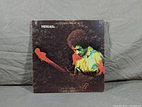 Front cover of Jimi Hendrix Band of Gypsies vinyl LP showing colorful image of Jimi Hendrix playing guitar