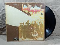 Front cover of Led Zeppelin II album with vinyl disc partly visible.