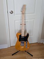 Full view of the electric guitar mounted on stand