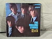 Front cover of The Rolling Stones 12 x 5 LP album showing band members and title.