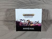 Sealed box of Warhammer Age of Sigmar Champions booster packs showing front artwork and branding