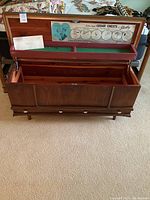 Front view of open cedar chest showing interior divided felt lined tray and base drawer with knobs