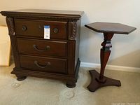 Front view of the nightstand and the small accent table side by side on carpeted floor.