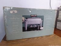 Box of Kirkland stainless steel chafer showing front label with product image and features.